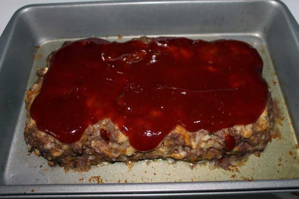 cooked meatloaf with barbecue sauce drizzled on top