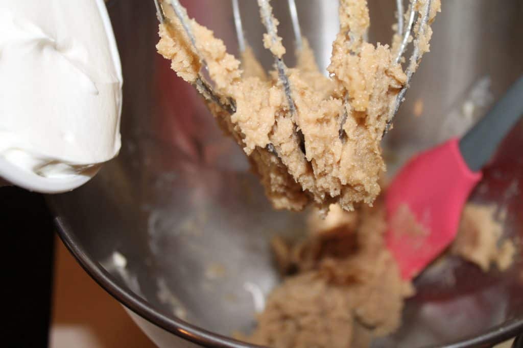 adding sour cream to the creamed butter and sugar mixture