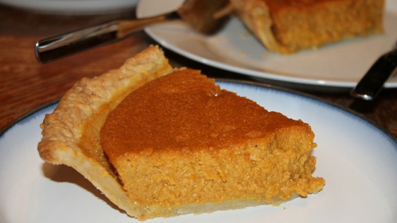 a close up image of the pumpkin pie slice on a plate
