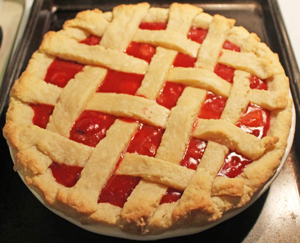 baked strawberry pie on a cookie sheet