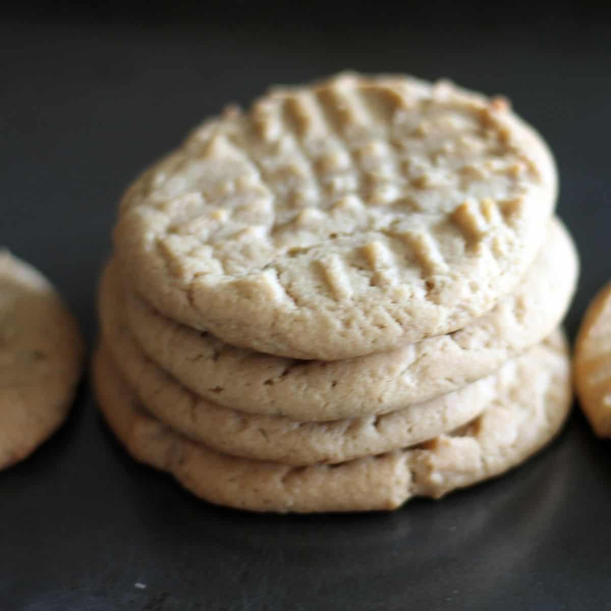 homemade peanut butter cookies stacked in a pile