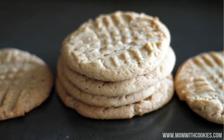 overhead image of peanut butter cookies on a platter with four cookies in the center stacked on top of each other