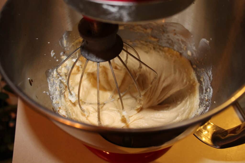 Using a whisk attachment on a kitchenaid mixer to beat the ingredients together 