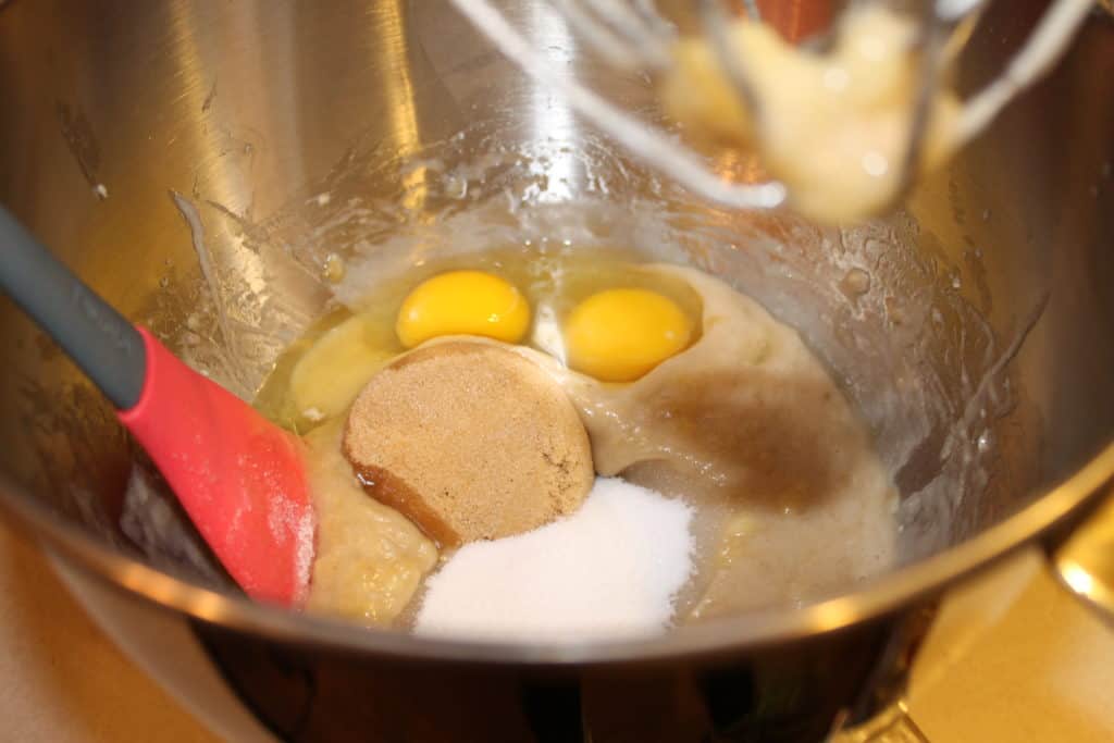 Adding the eggs and sugar to the mixing bowl.