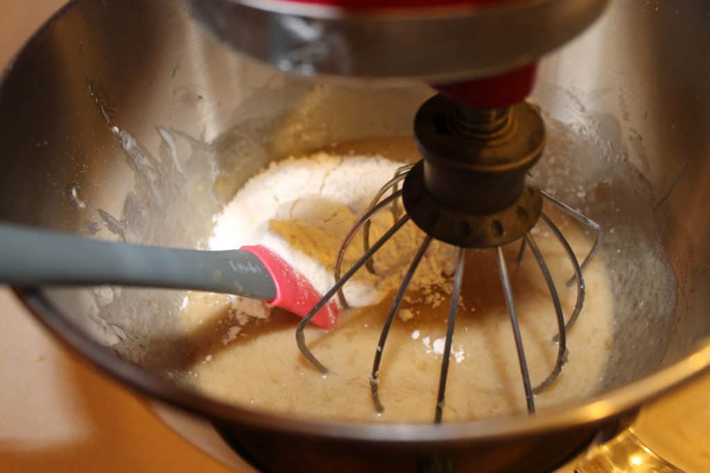 Adding flour to the batter.