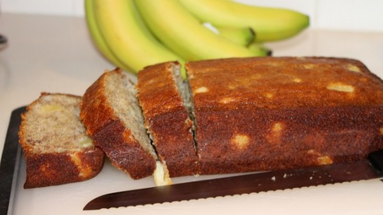 Sliced Pineapple Banana Bread on a cutting board to show the pineapple chunks in the bread