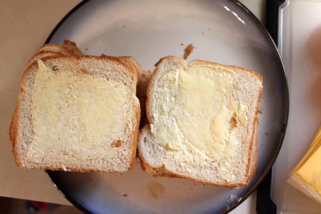 Butter that has been spread onto the slices of bread.