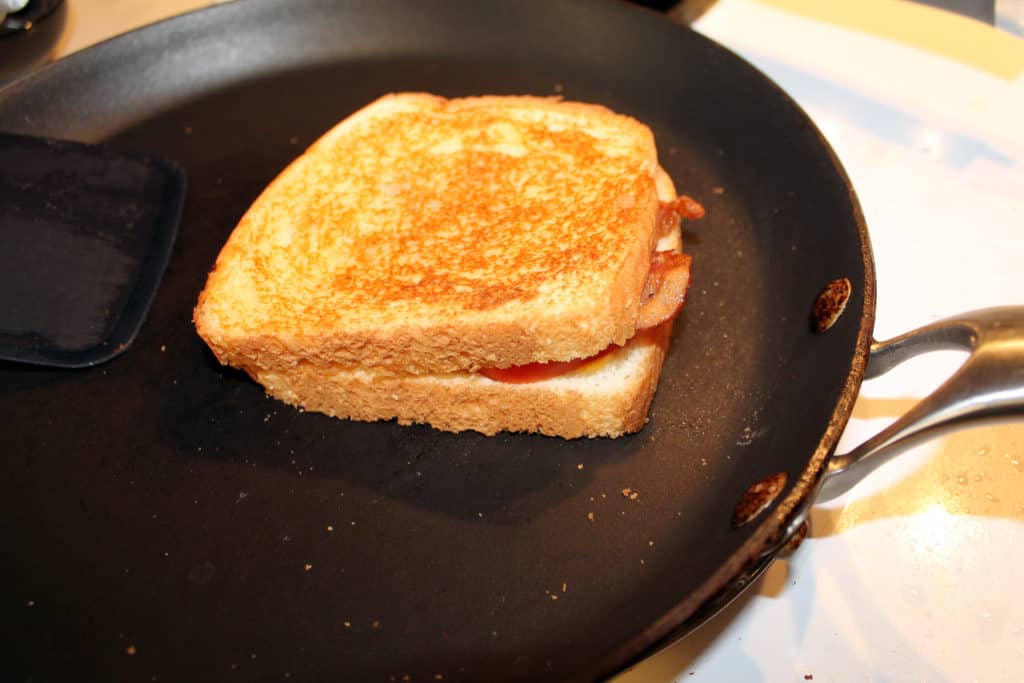 Flipped the grilled cheese onto its other side to let it cook