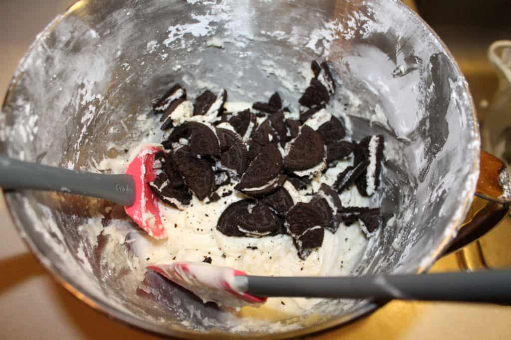 Melted white chocolate mixed with cream cheese mixture. Smashed oreos are also in the bowl. 