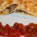 sliced cheeseburger quesadillas on a plate with salsa