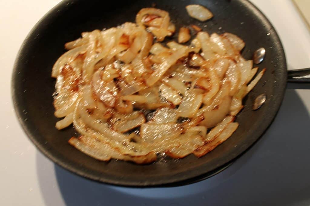 a small frying pan with sautéed onions