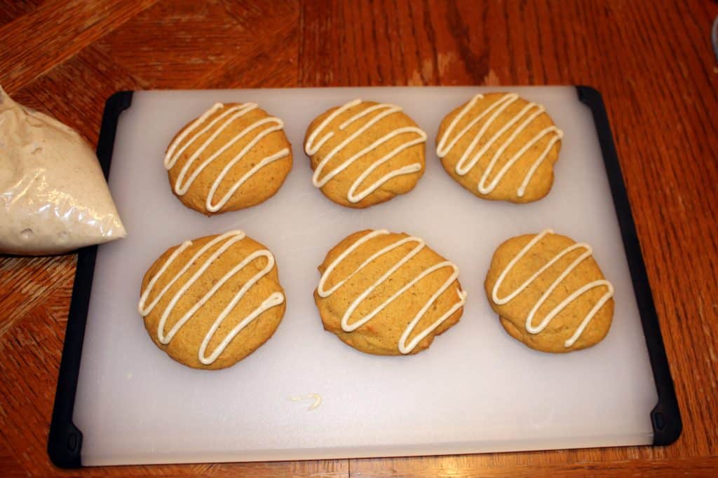 Pumpkin cookies that have been drizzled with homemade brown butter icing.