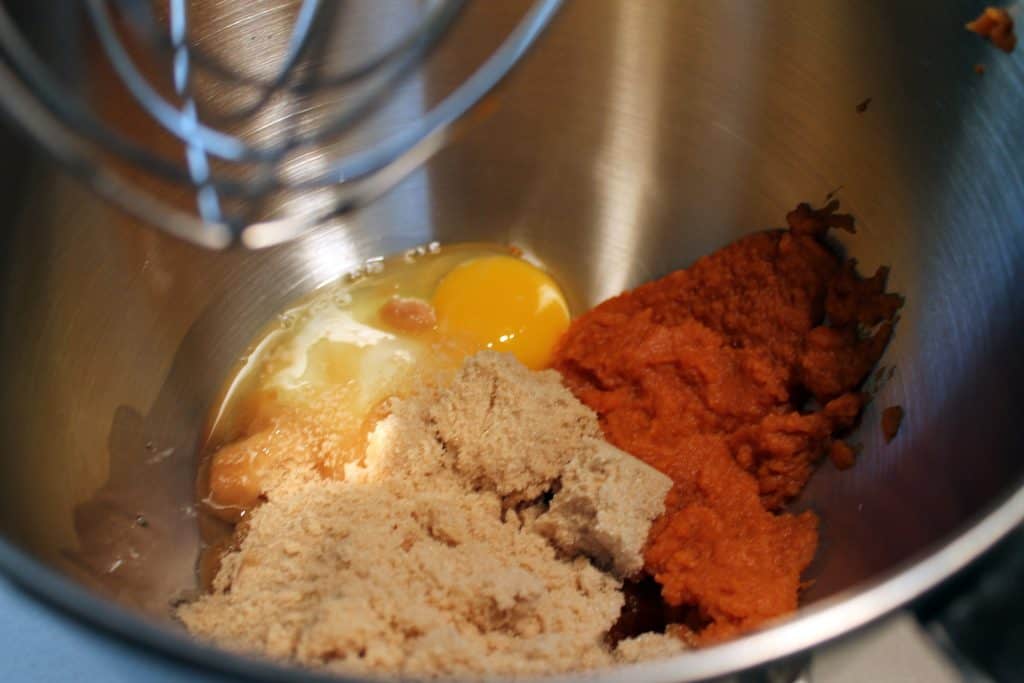 Pumpkin, sugars, and egg in a bowl.