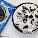 a no bake oreo cream pie on a counter top next to a package of oreo cookies