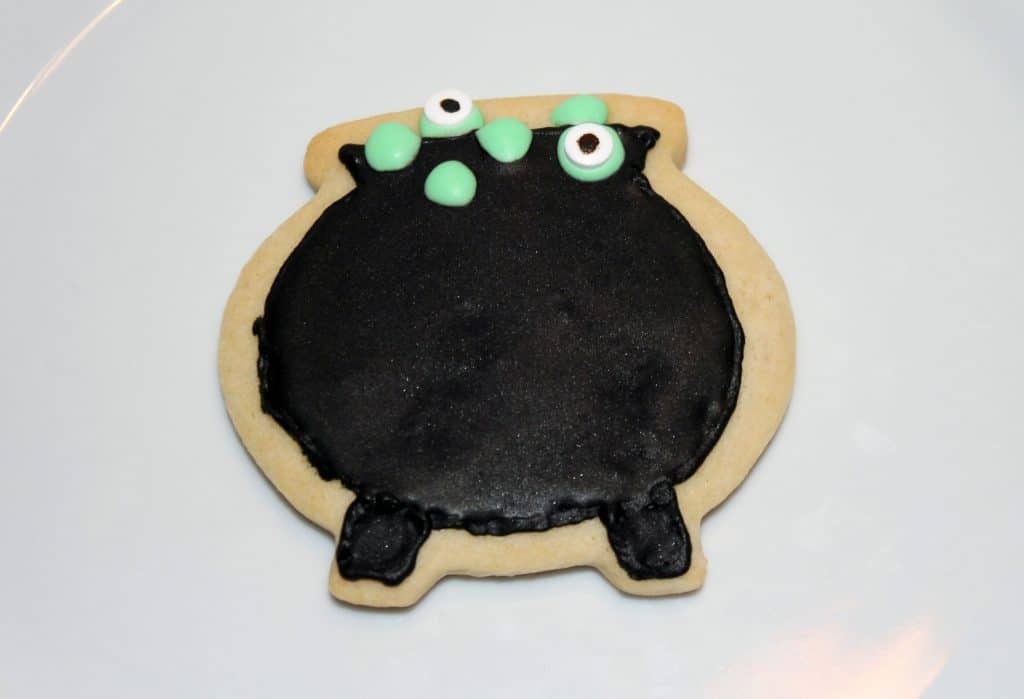 Add some green royal icing and some candy eyes to really make these witches cauldron cookies pop.