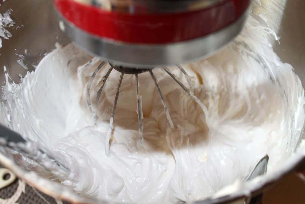 Adding cool whip to the cream cheese mixture.