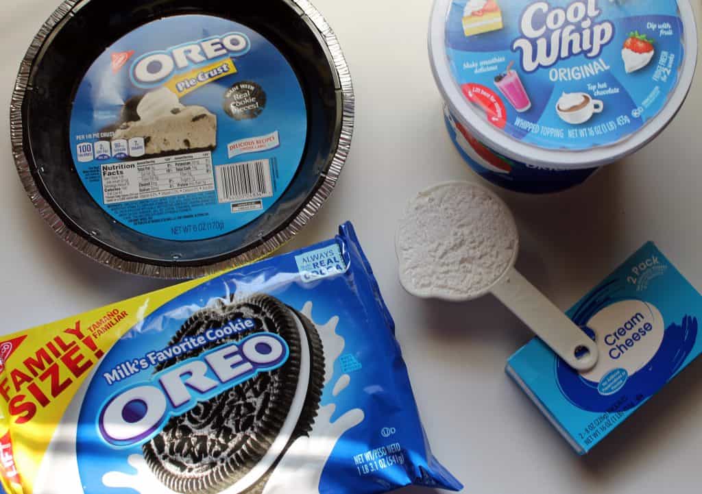 Oreo cream pie ingredients shown including oreo cookies, oreo cookie pie crust, powdered sugar, cream cheese, and cool whip