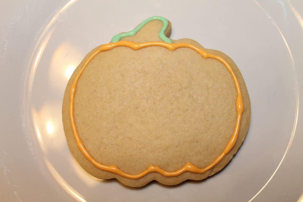 Pumkin cookie stem outline with green royal icing.