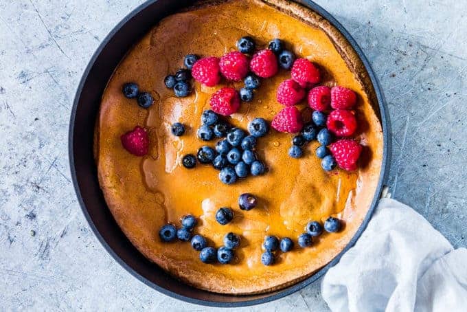 a pumpkin pancake topped with blueberries and raspberries