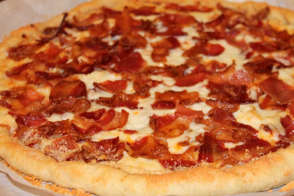 close up image of the cooked bacon pizza fresh from the oven