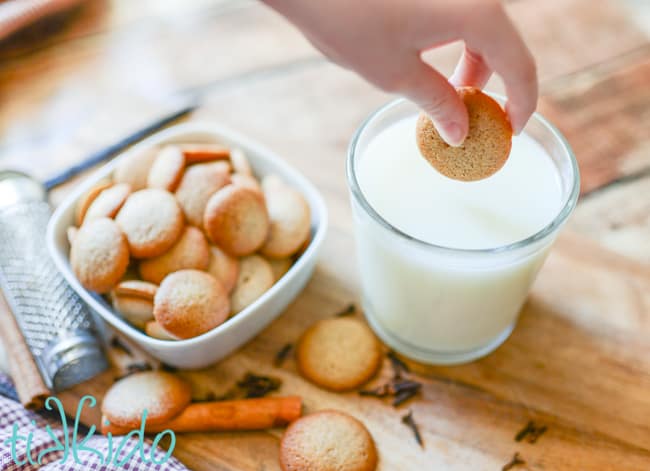 pumpkin spice wafers being dunked into a glass of milk