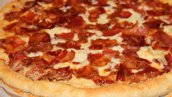 close up image of the cooked bacon pizza fresh from the oven