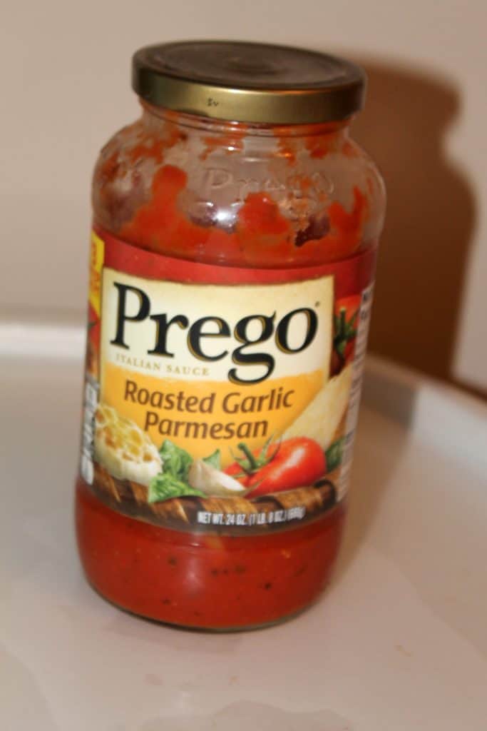 a glass jar of Prego Roasted Garlic Parmesan sauce