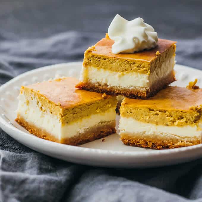 a plate of pumpkin cheesecake bars