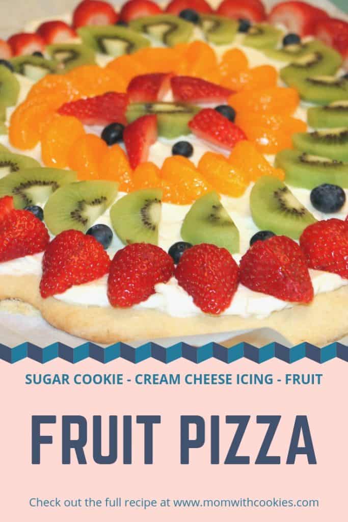 Fruit pizza decorated with cream cheese and sliced fruits