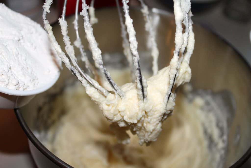 Adding flour to the mixing bowl.