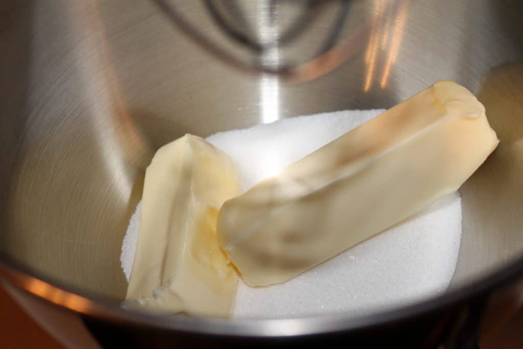 Softened butter and sugar in a mixing bowl.