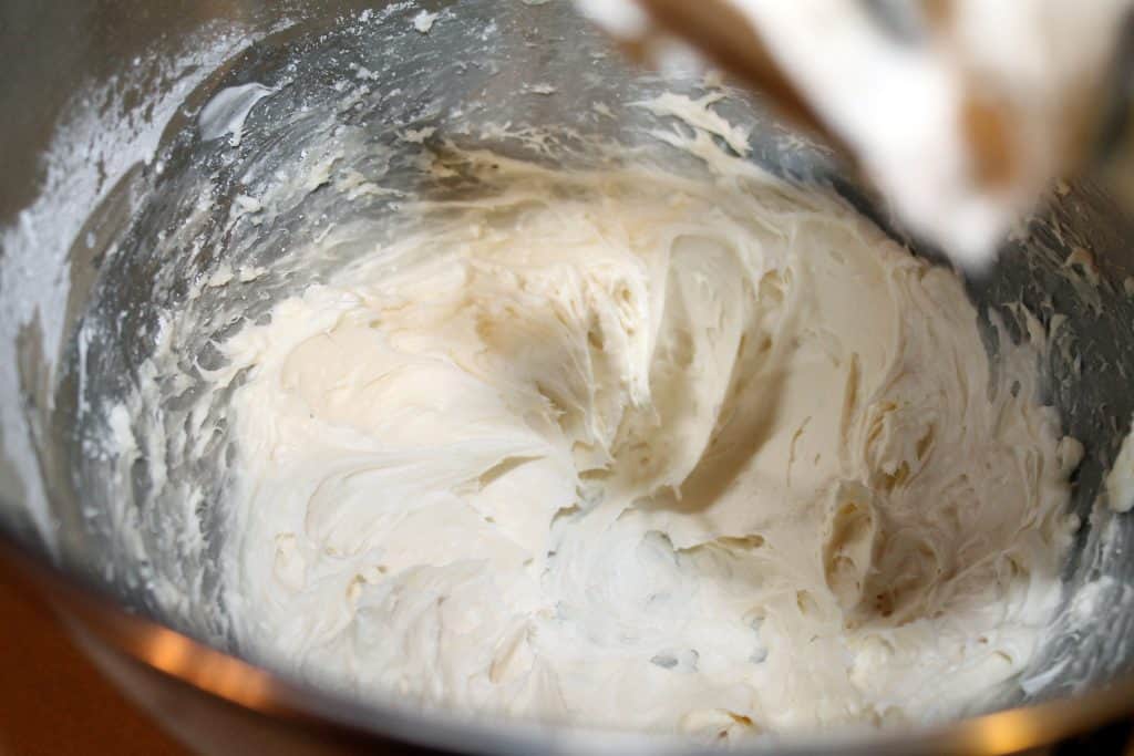 Finished cream cheese icing in a mixing bowl