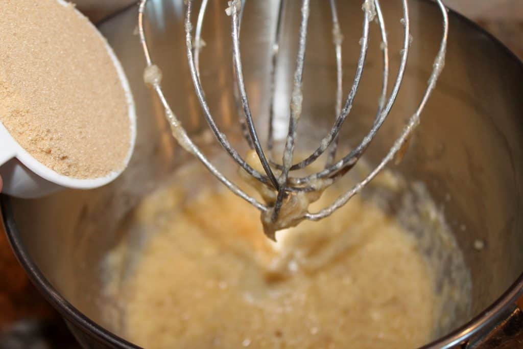 adding brown sugar to the mixing bowl