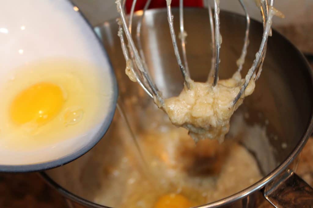 adding egg to the mixing bowl