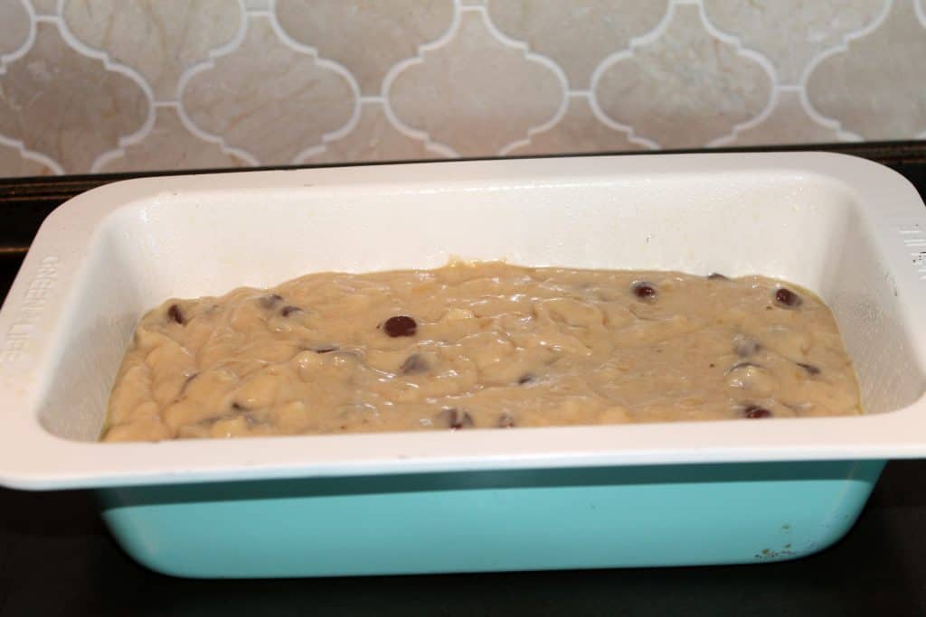 a loaf pan filled with chocolate chip banana bread batter