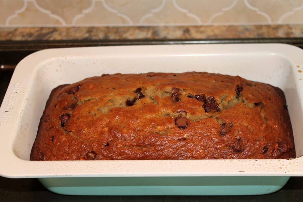 cooked chocolate chip banana bread cooling in the pan