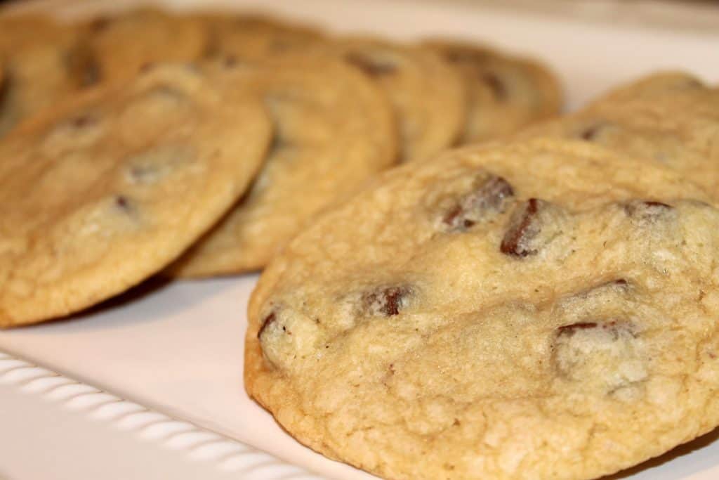 close up image of chocolate chunk cookies laid out on a serving tray