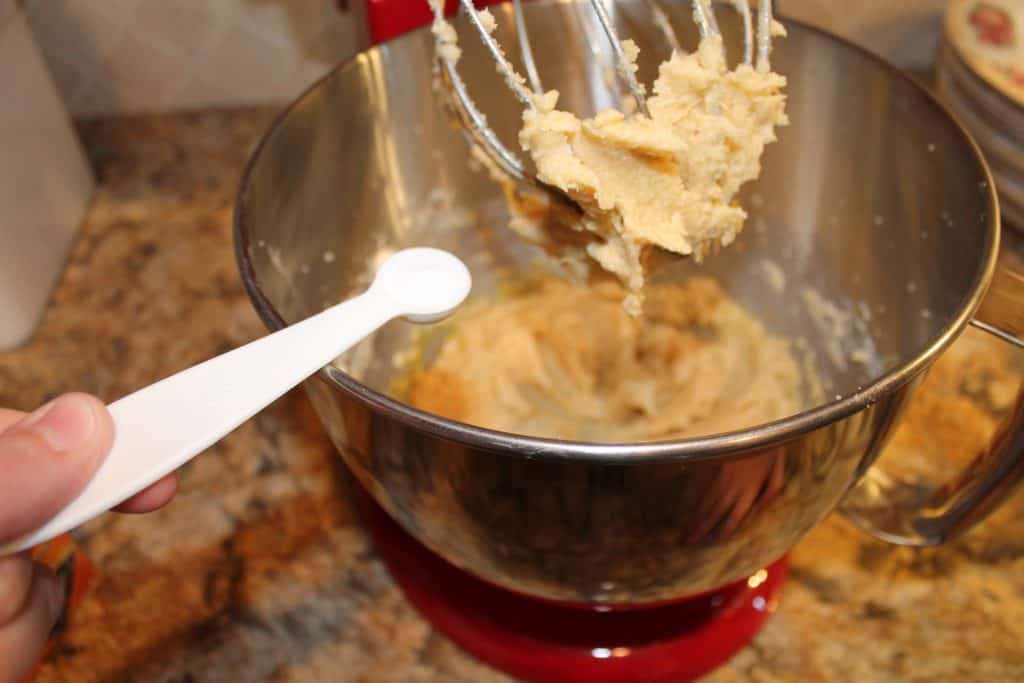 adding baking soda to the mixing bowl