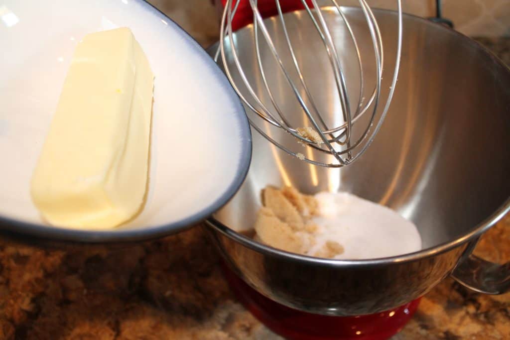 adding butter, granulated sugar and brown sugar to a mixing bowl