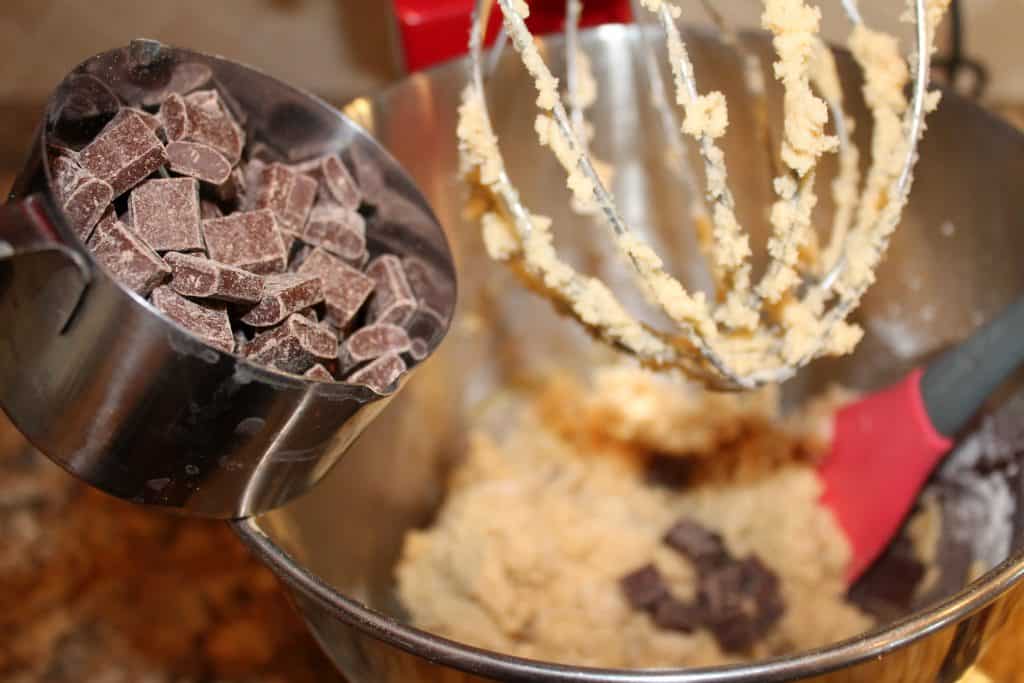 adding chocolate chunks to the cookie dough