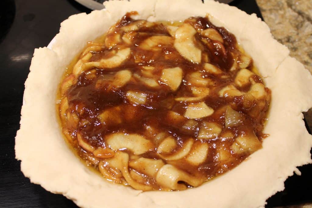 Pre-baked apple pie filling in an unbaked pie crust