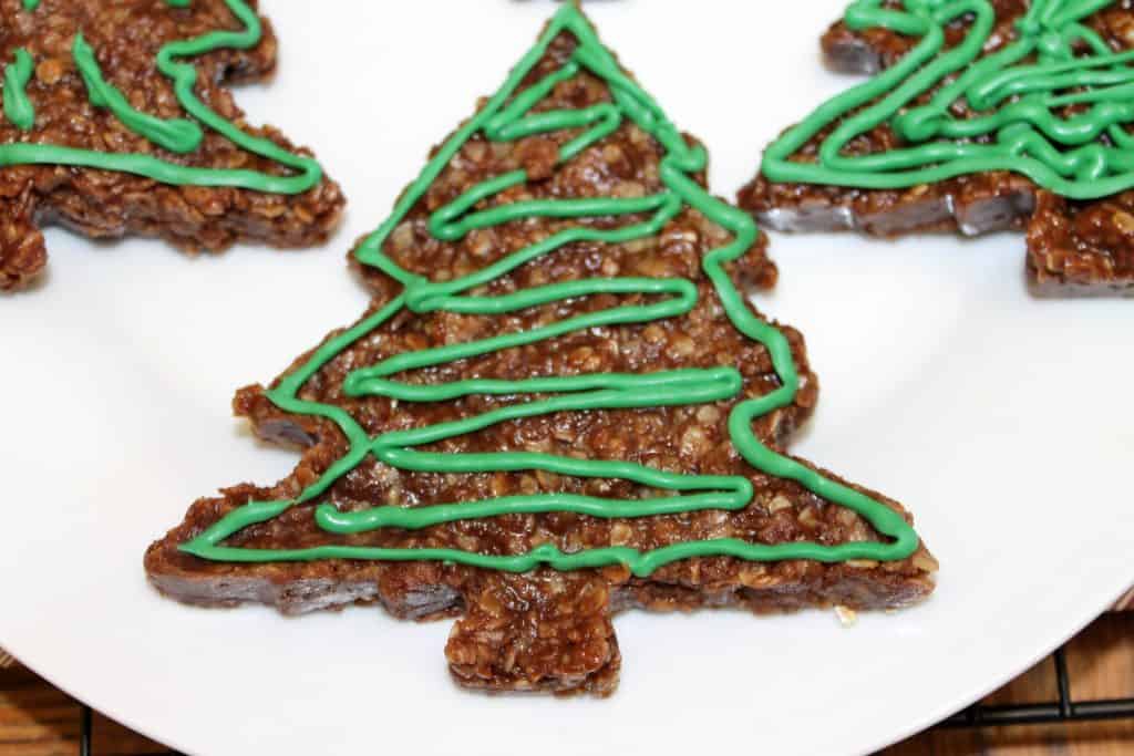 a close up image of the christmas tree no bake cookies on a plate