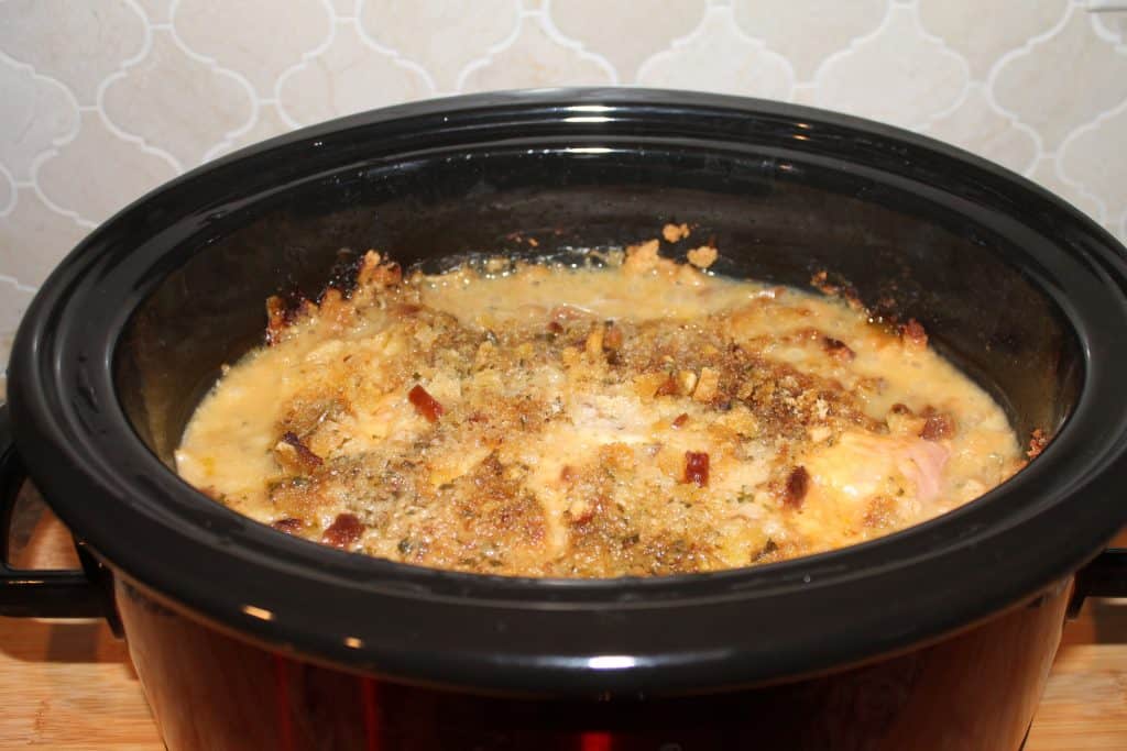 A crockpot with chicken cordon bleu casserole in it