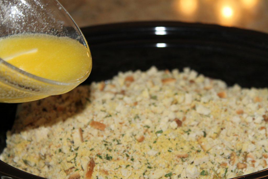 Pouring melted butter over the stuffing