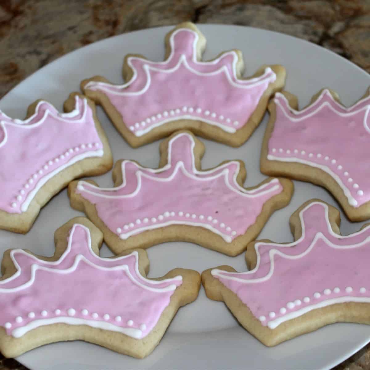 tiara shaped cookies with pink and white royal icing