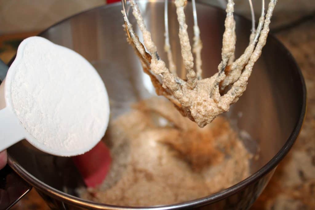 Adding flour into the mixing bowl.