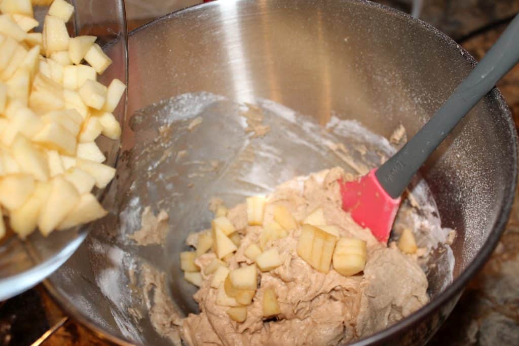 Adding diced apples into the muffin batter.