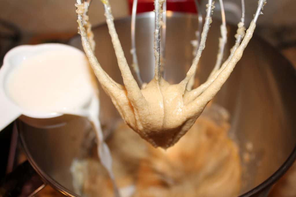 Pouring milk into the mixing bowl. 