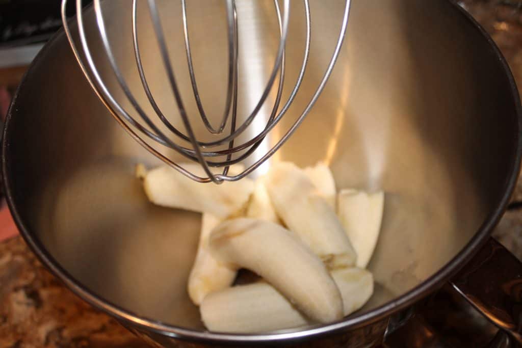 adding bananas to the mixing bowl