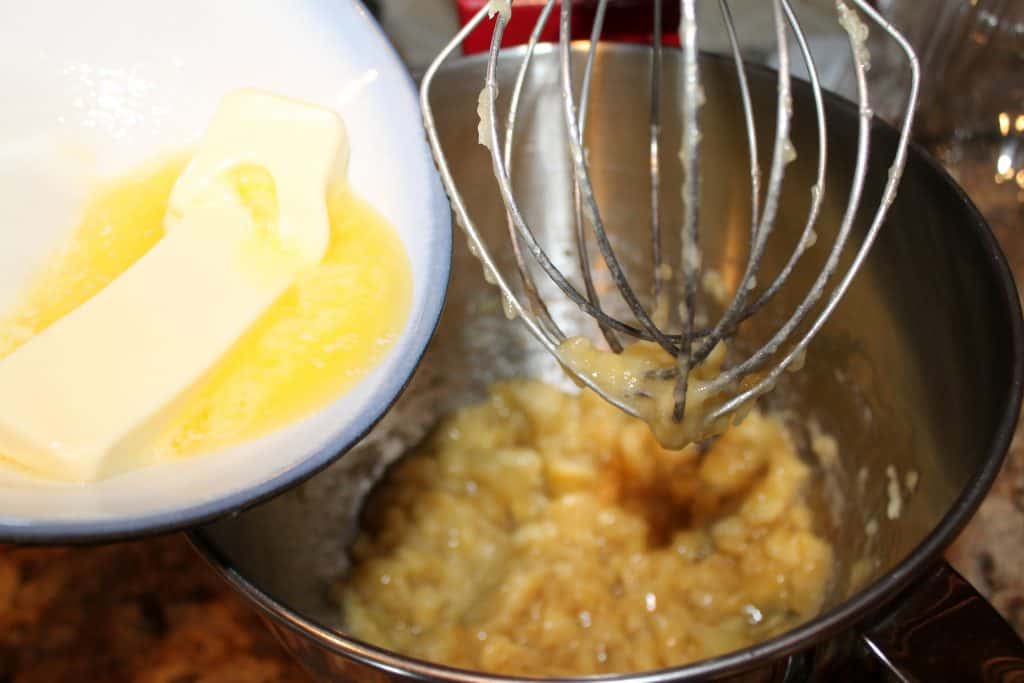 adding melted butter to the mixing bowl